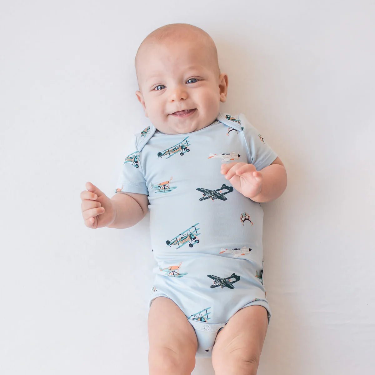 Kyte Baby Bodysuit in Take Off - Princess and the Pea Boutique