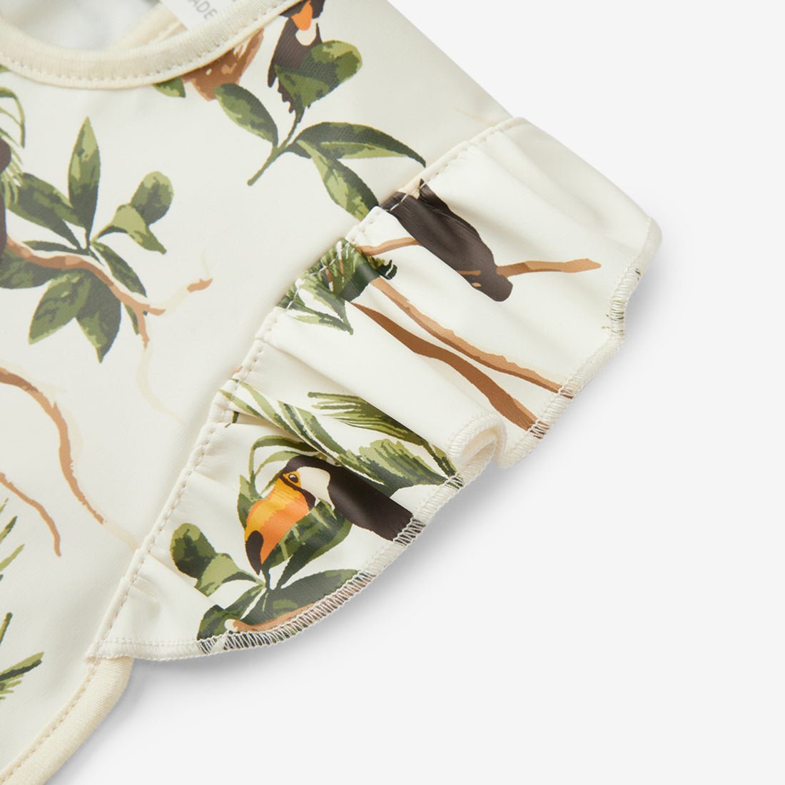 Milkbarn White Toucan Ruffle Pocket Bib - Princess and the Pea Boutique