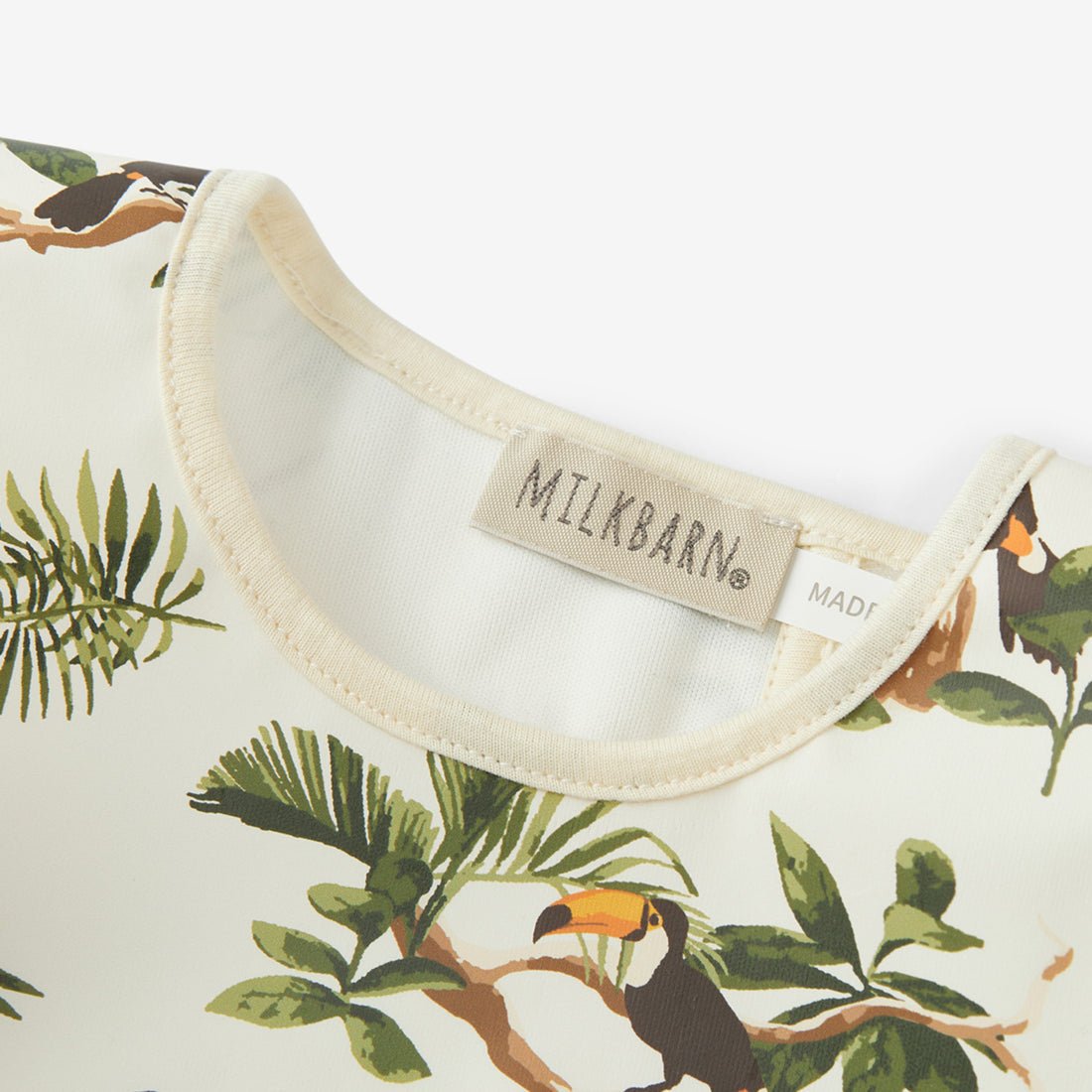 Milkbarn White Toucan Ruffle Pocket Bib - Princess and the Pea Boutique
